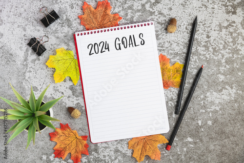 Notebook with 2024 goals written on it to make new plans in the new year photo