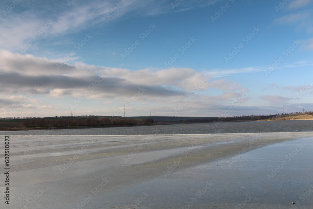 A snowy field with a cloudy sky