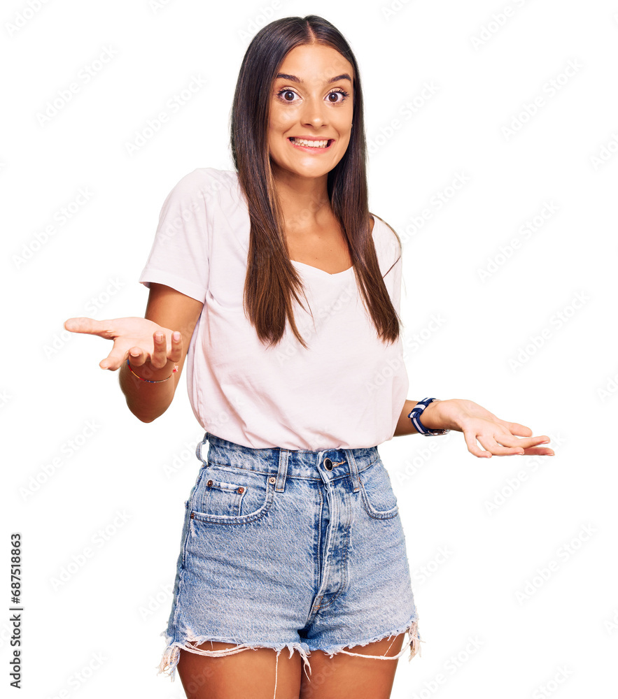 Young hispanic woman wearing casual white tshirt smiling cheerful with open arms as friendly welcome, positive and confident greetings Young hispanic woman wearing casual white tshirt smiling cheerful with open arms as friendly welcome, positive and confident greetings
