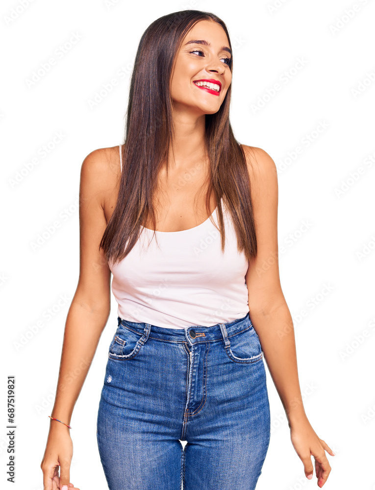 Obraz premium Young hispanic woman wearing casual clothes looking away to side with smile on face, natural expression. laughing confident.