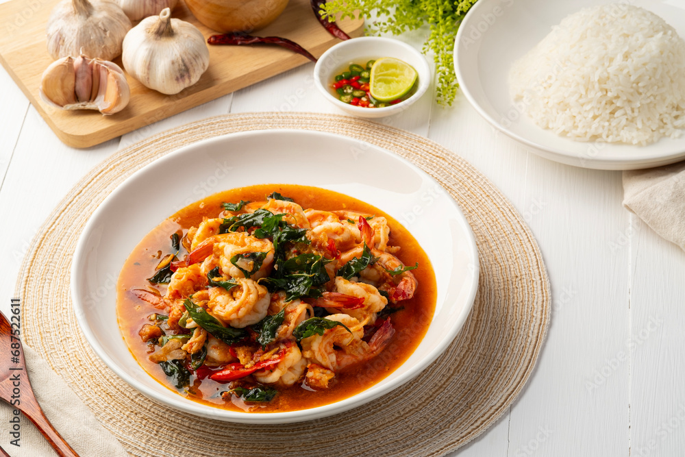 Stir fried shrimp with crispy thai basil on white plate,thai spicy food Stir fried shrimp with crispy thai basil on white plate,thai spicy food