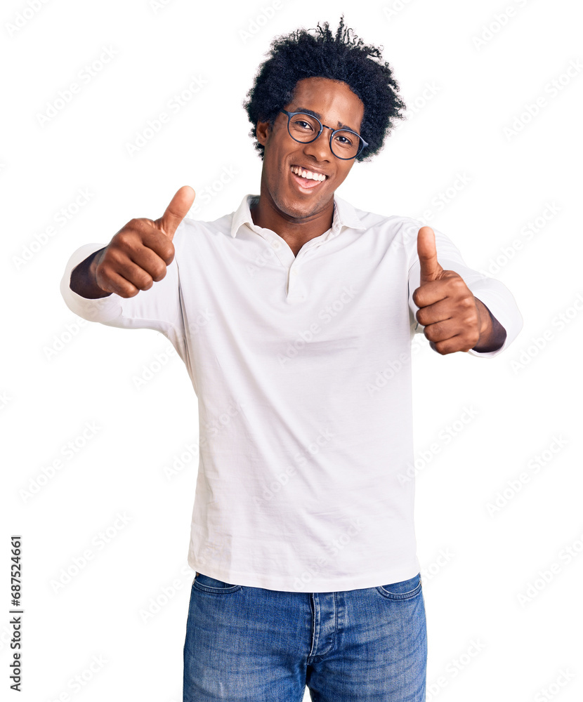 Handsome african american man with afro hair wearing casual clothes and glasses approving doing positive gesture with hand, thumbs up smiling and happy for success. winner gesture. Handsome african american man with afro hair wearing casual clothes and glasses approving doing positive gesture with hand, thumbs up smiling and happy for success. winner gesture.