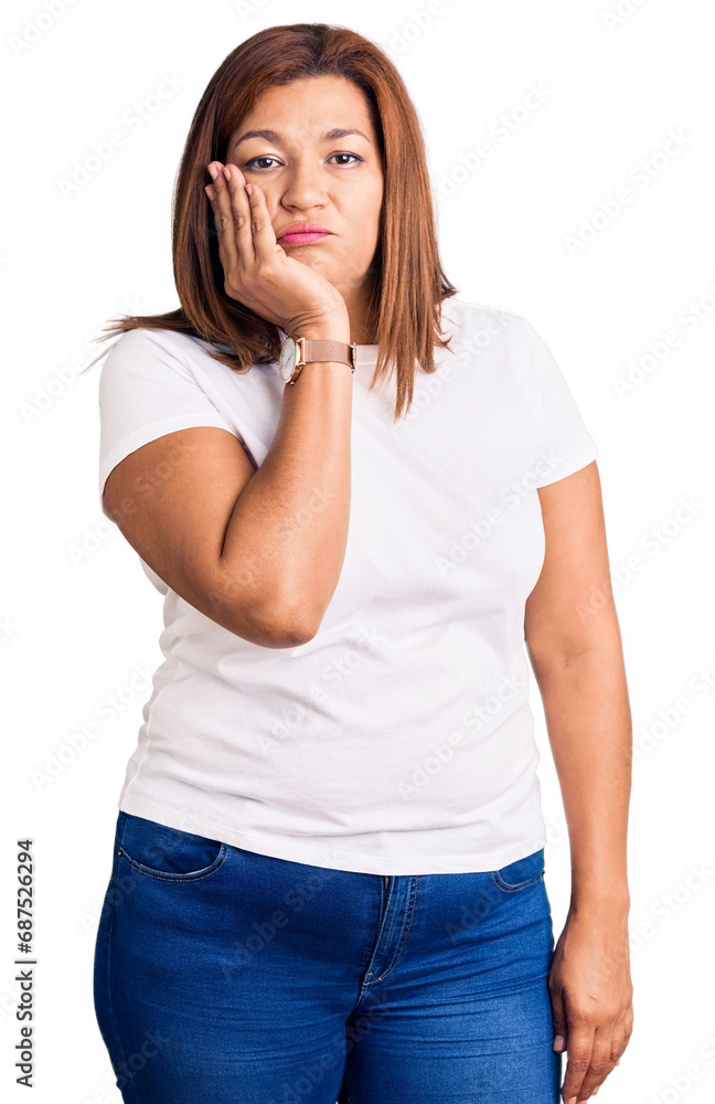 Middle age latin woman wearing casual white tshirt thinking looking tired and bored with depression problems with crossed arms. Middle age latin woman wearing casual white tshirt thinking looking tired and bored with depression problems with crossed arms.