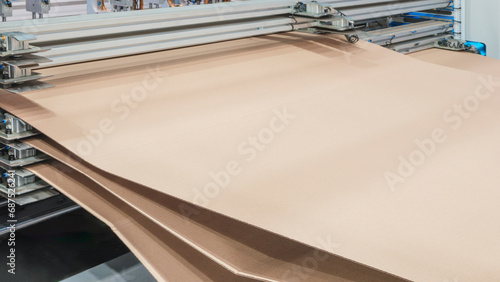 Modern machine for printing and packaging in corrugated cardboard. Industrial concept background photo