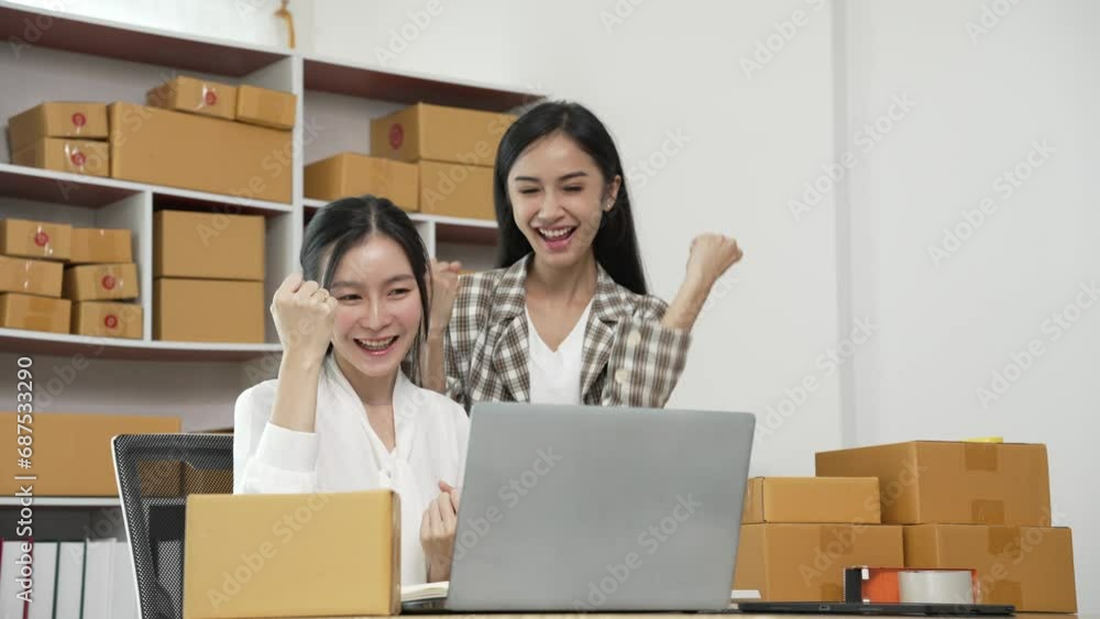Two young Asian women are happy and excited after receiving a new order from an SME customer. Commercial inspection online marketing SME entrepreneur packaging box 4k video Two young Asian women are happy and excited after receiving a new order from an SME customer. Commercial inspection online marketing SME entrepreneur packaging box 4k video