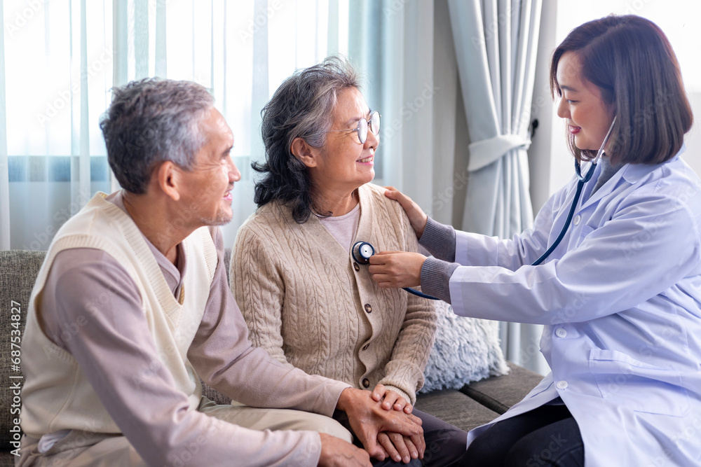 Fototapeta premium Senior couple got medical service visit from caregiver doctor at home while having medical checkup on heart and cardiovascular system for health care and pension welfare insurance