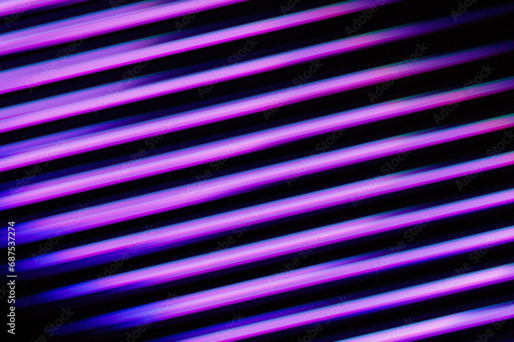 Fluorescent background. Blur curved texture. Futuristic light. Defocused neon pink purple blue color diagonal stripes glow on dark ridged abstract overlay Fluorescent background. Blur curved texture. Futuristic light. Defocused neon pink purple blue color diagonal stripes glow on dark ridged abstract overlay