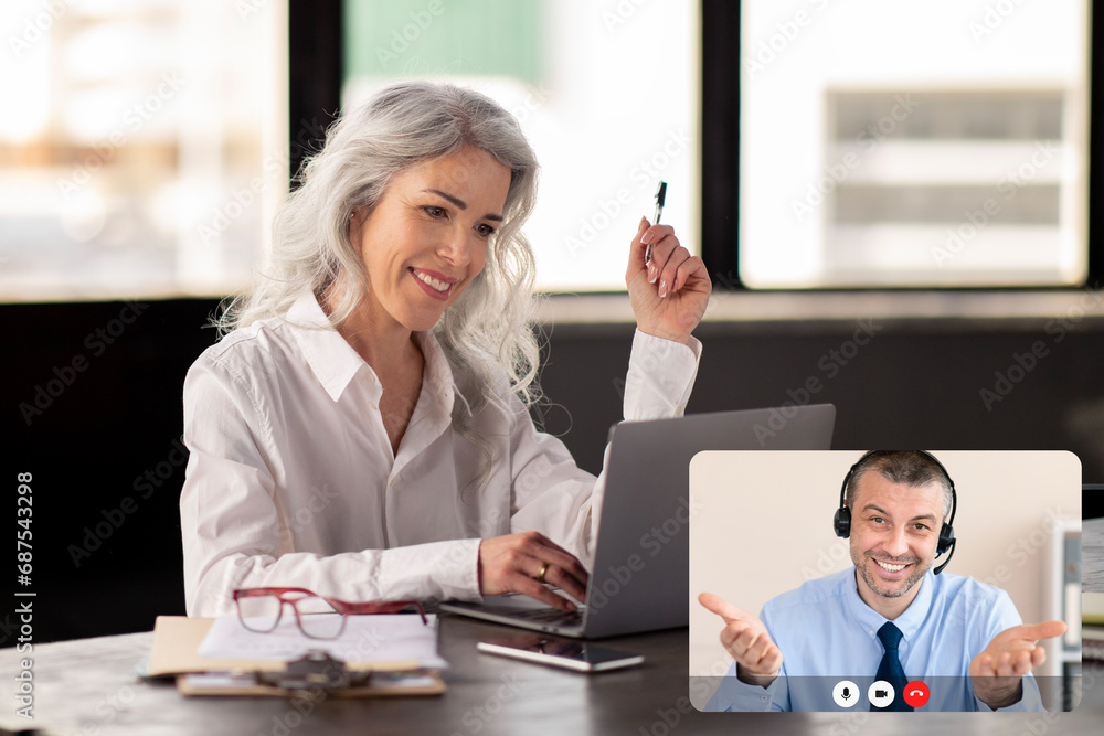 Mature woman entrepreneur have video chat with business consultant Mature woman entrepreneur have video chat with business consultant