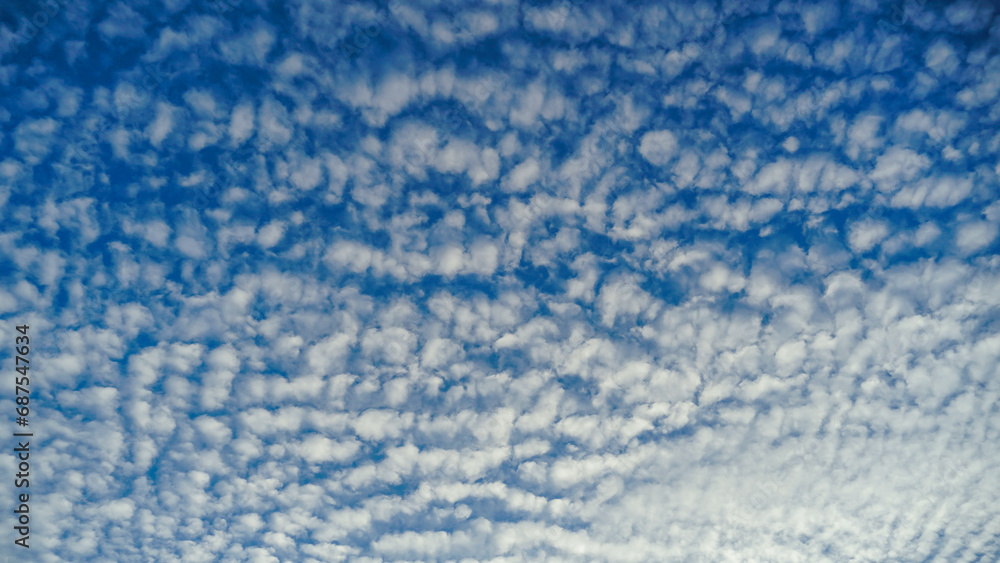 Blue sky and White cloud nature background. A daytime view of clouds and blue sky. Sparse cumulus cloud in blue sky, ground view. Blue sky and White cloud nature background. A daytime view of clouds and blue sky. Sparse cumulus cloud in blue sky, ground view.
