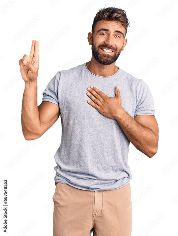 Young hispanic man wearing casual clothes smiling swearing with hand on chest and fingers up, making a loyalty promise oath Young hispanic man wearing casual clothes smiling swearing with hand on chest and fingers up, making a loyalty promise oath