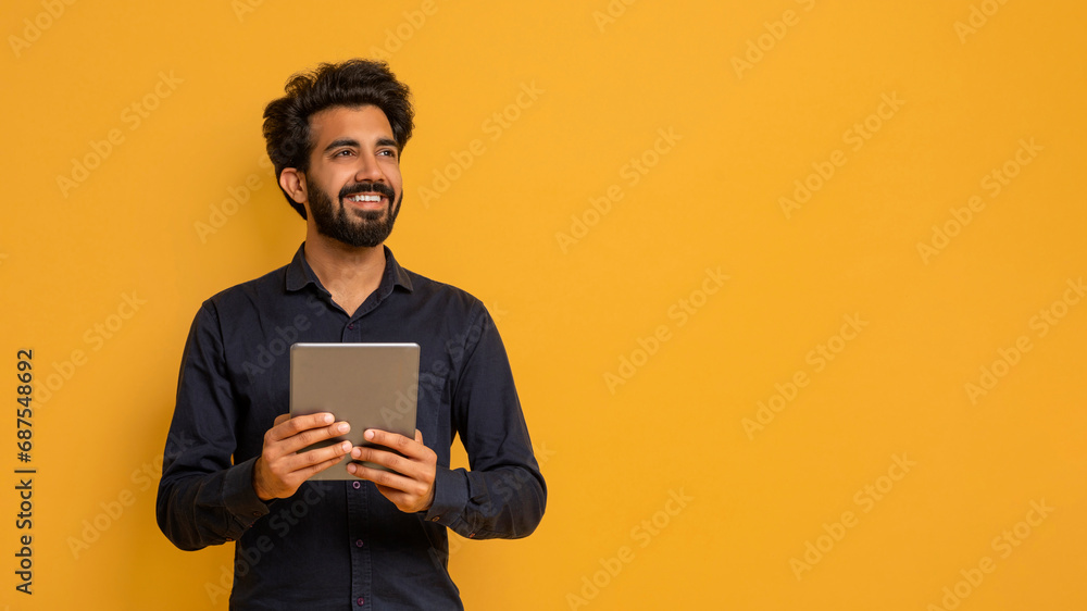 Young Indian Man Holding Digital Tablet And Looking Away, Young Indian Man Holding Digital Tablet And Looking Away,
