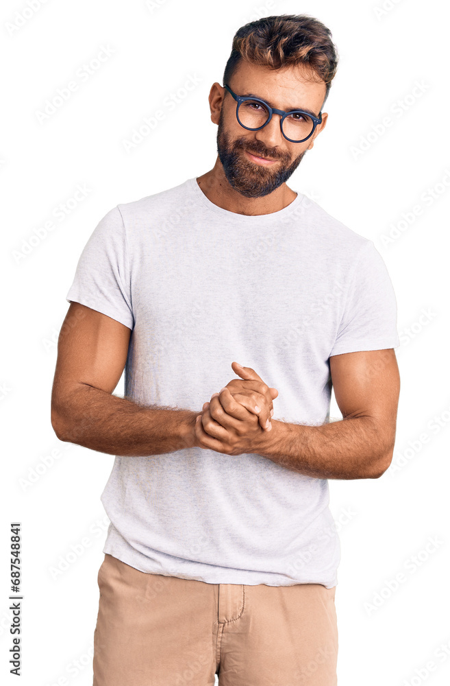 Young hispanic man wearing casual clothes and glasses with hands together and crossed fingers smiling relaxed and cheerful. success and optimistic Young hispanic man wearing casual clothes and glasses with hands together and crossed fingers smiling relaxed and cheerful. success and optimistic