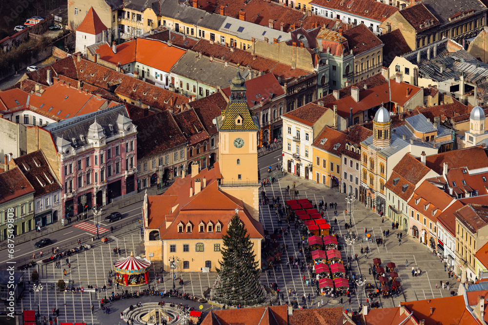 From above, the Christmas market resembles a festive village, alive with twinkling lights and bustling stalls. The aerial view captures a tapestry of colors from the vibrant decorations.