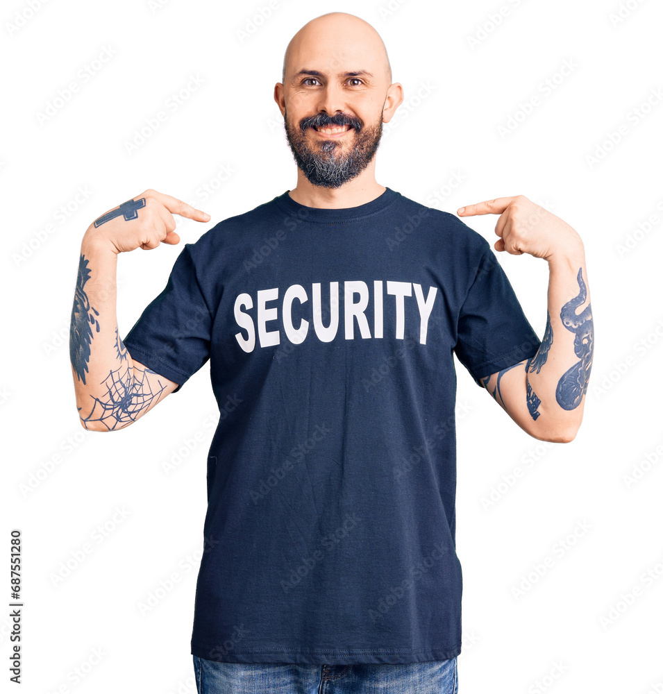 Young handsome man wearing security t shirt looking confident with smile on face, pointing oneself with fingers proud and happy. Young handsome man wearing security t shirt looking confident with smile on face, pointing oneself with fingers proud and happy.