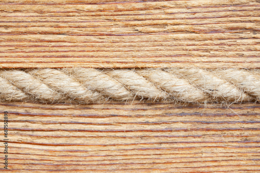 Linen rope in wooden wall background. Heat isolation system. Antique style mountain hut closeup interior wall texture. Wood pattern lines. Linen rope in wooden wall background. Heat isolation system. Antique style mountain hut closeup interior wall texture. Wood pattern lines.