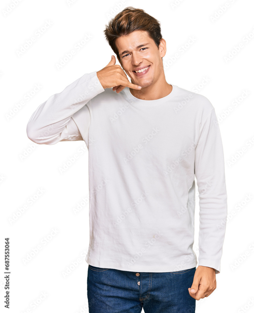 Handsome caucasian man wearing casual white sweater smiling doing phone gesture with hand and fingers like talking on the telephone. communicating concepts. Handsome caucasian man wearing casual white sweater smiling doing phone gesture with hand and fingers like talking on the telephone. communicating concepts.