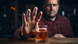 man refuses say no and avoid to drink an alcohol whiskey , stopping hand sign male, alcoholism treatment, alcohol addiction, quit booze, Stop Drinking Alcohol. Refuse Glass liquor, unhealthy, reject