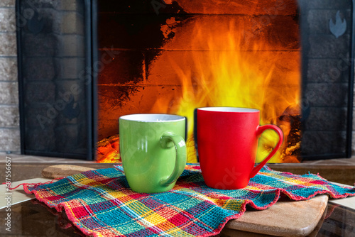 Cozy fireplace, winter holidays and coffee mugs