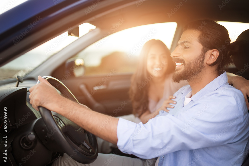 Joyful middle eastern couple in car on sunny trip Joyful middle eastern couple in car on sunny trip