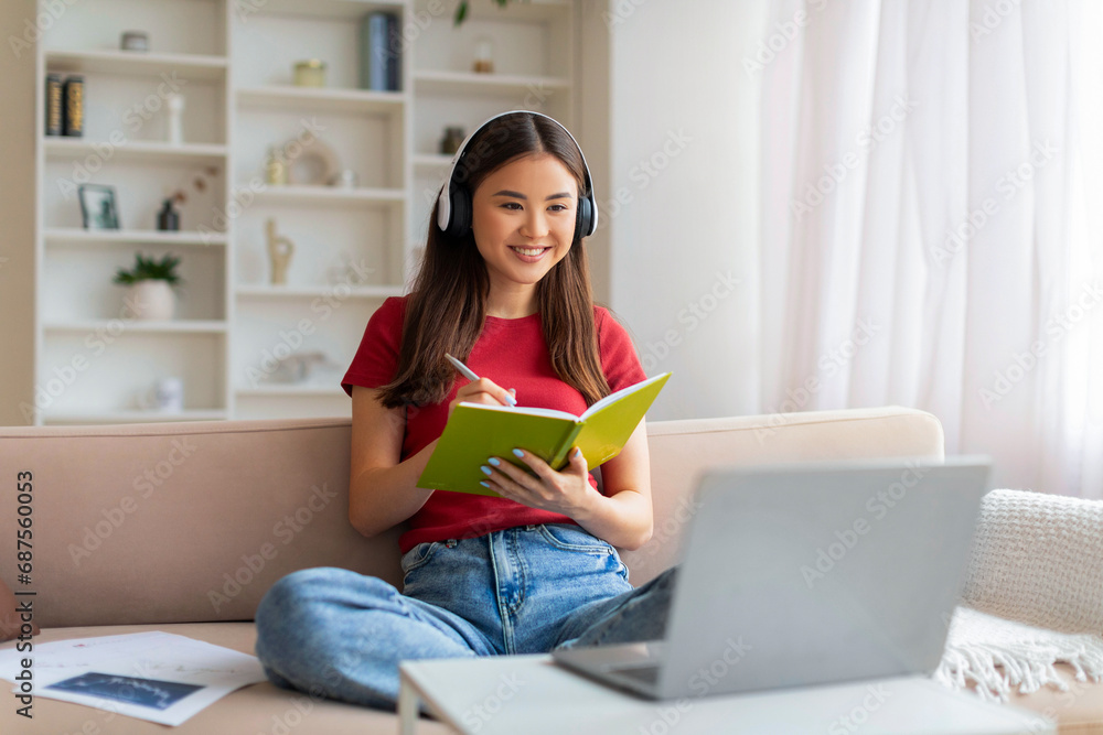 Young Asian Woman In Headset Study Online With Laptop From Home Young Asian Woman In Headset Study Online With Laptop From Home