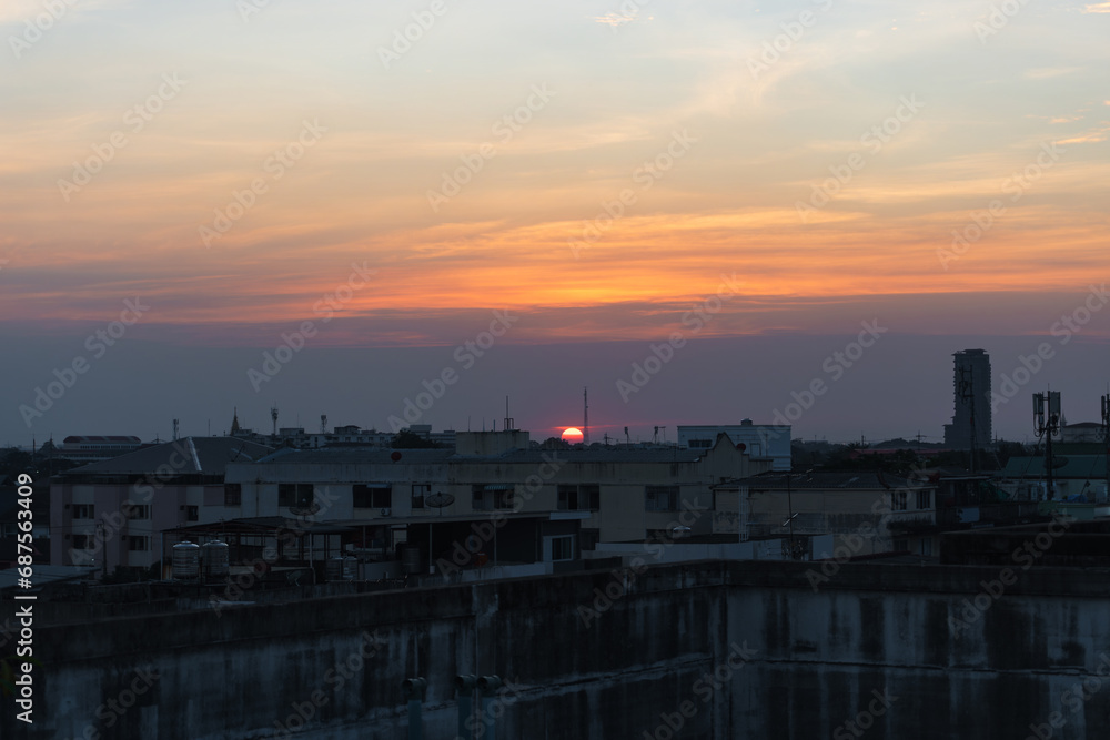 Sunset in Bangkok, Thailand, silhouette of big building in city with dramatic vanilla sky for background.