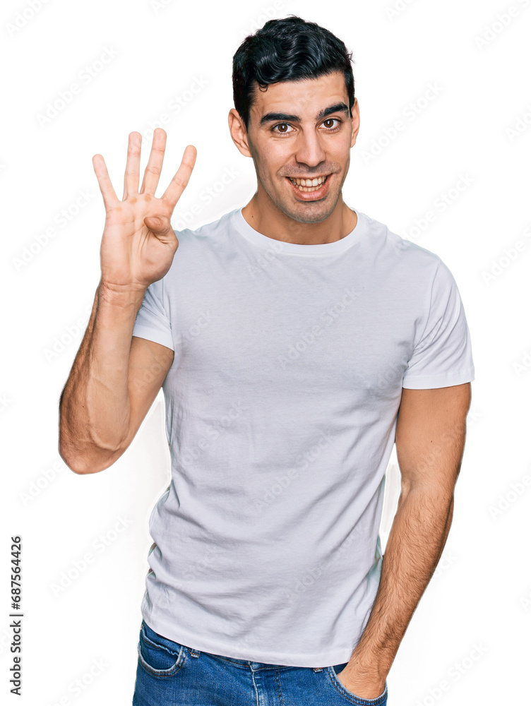 Fototapeta premium Handsome hispanic man wearing casual white t shirt showing and pointing up with fingers number four while smiling confident and happy.