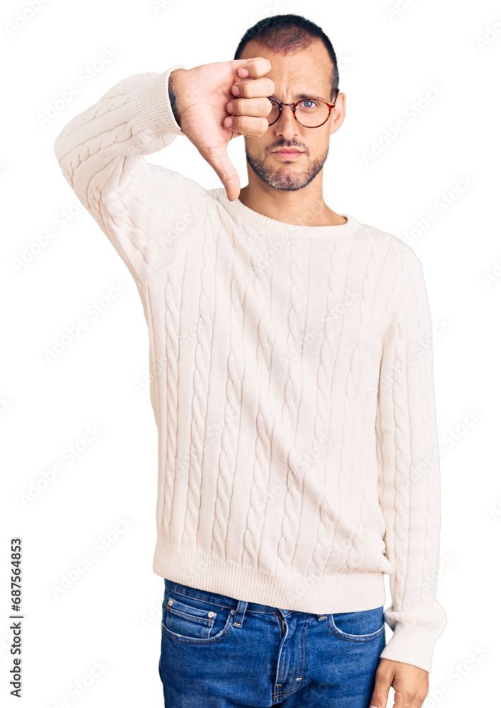 Young handsome man wearing casual clothes and glasses looking unhappy and angry showing rejection and negative with thumbs down gesture. bad expression. Young handsome man wearing casual clothes and glasses looking unhappy and angry showing rejection and negative with thumbs down gesture. bad expression.