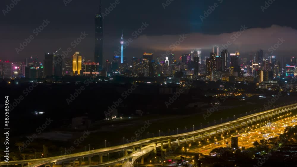 Cinematic aerial drone night scene hyperlapse of Kuala Lumpur city skyline with elevated highway, residential and city skyline. Pan right Cinematic aerial drone night scene hyperlapse of Kuala Lumpur city skyline with elevated highway, residential and city skyline. Pan right