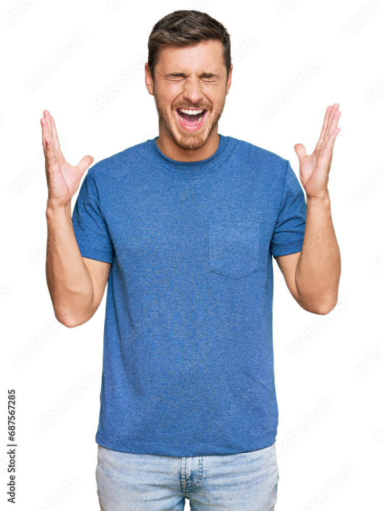Fototapeta premium Handsome caucasian man wearing casual clothes celebrating mad and crazy for success with arms raised and closed eyes screaming excited. winner concept