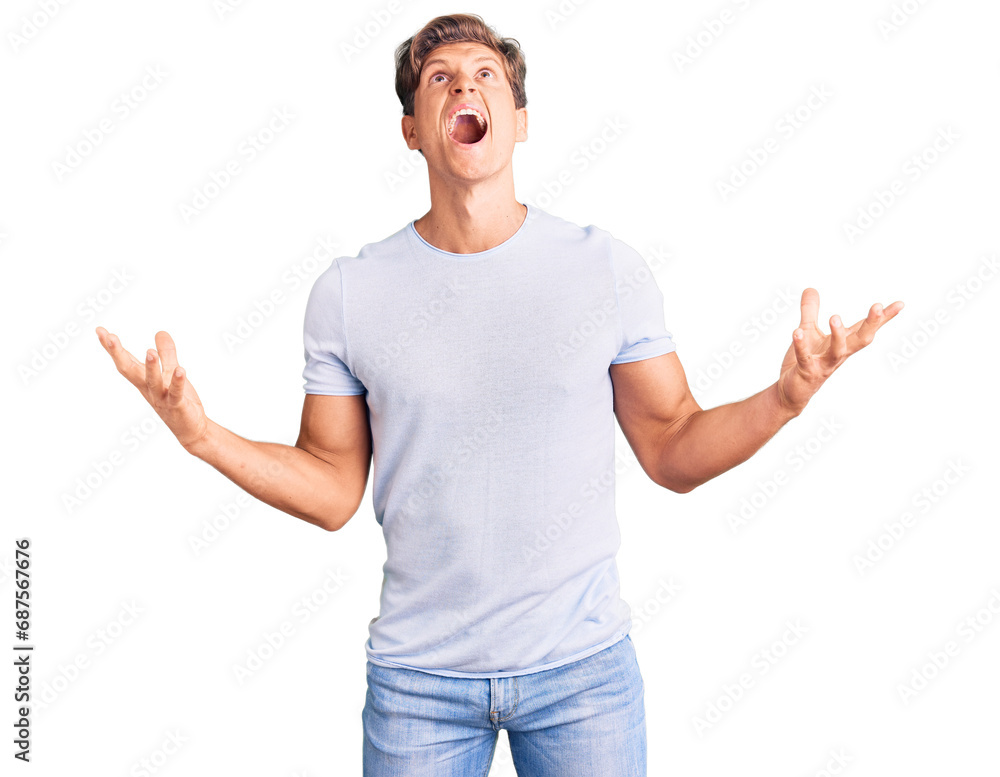 Young handsome man wearing casual clothes crazy and mad shouting and yelling with aggressive expression and arms raised. frustration concept. Young handsome man wearing casual clothes crazy and mad shouting and yelling with aggressive expression and arms raised. frustration concept.