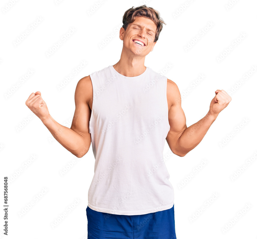 Young handsome man wearing sleveeless t shirt very happy and excited doing winner gesture with arms raised, smiling and screaming for success. celebration concept. Young handsome man wearing sleveeless t shirt very happy and excited doing winner gesture with arms raised, smiling and screaming for success. celebration concept.
