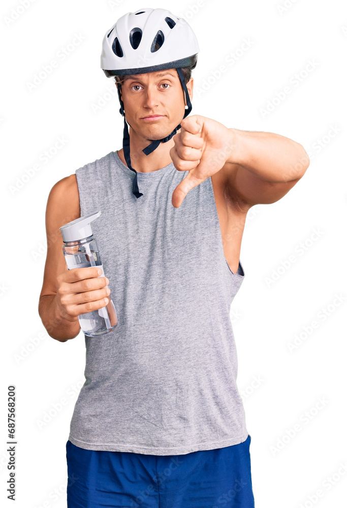 Young handsome man wearing bike helmet holding bottle of water with angry face, negative sign showing dislike with thumbs down, rejection concept Young handsome man wearing bike helmet holding bottle of water with angry face, negative sign showing dislike with thumbs down, rejection concept