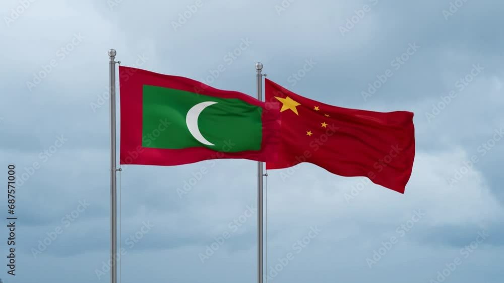 China flag and Maldives flag waving together on cloudy sky, endless seamless loop, two country relations concept China flag and Maldives flag waving together on cloudy sky, endless seamless loop, two country relations concept