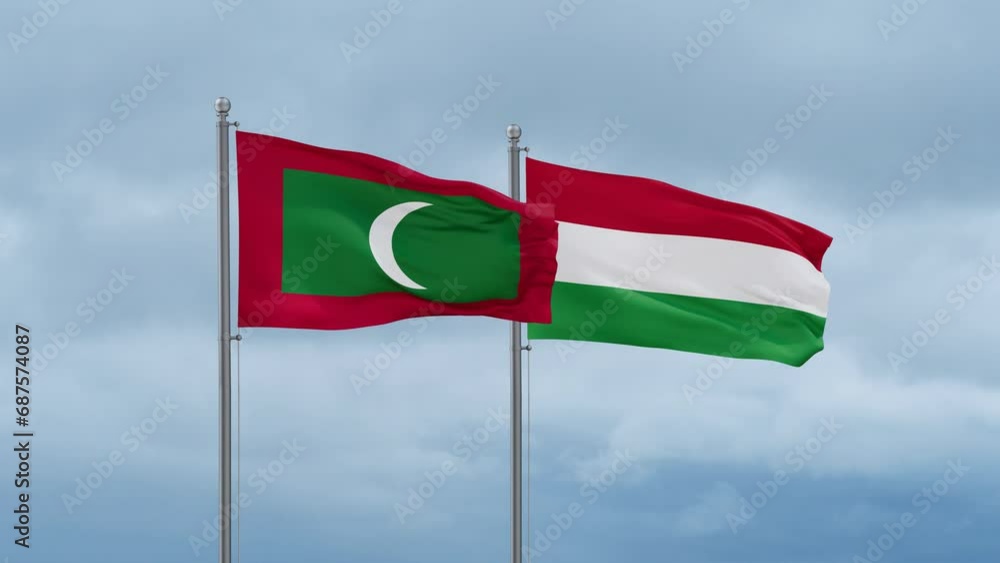 Hungary flag and Maldives flag waving together on cloudy sky, endless seamless loop, two country relations concept Hungary flag and Maldives flag waving together on cloudy sky, endless seamless loop, two country relations concept
