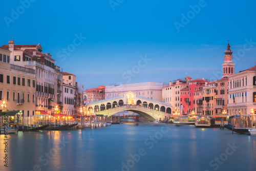 The Rialto Bridge illuminated at night at twilight over the Grand Canal in Venice  Italy.