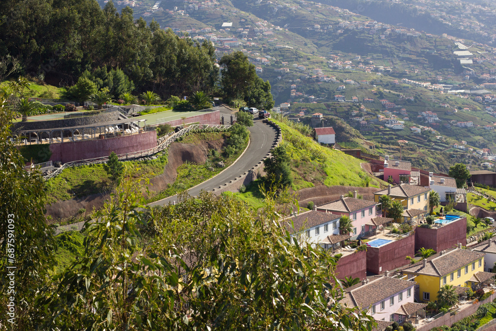 The Land of Eternal Spring. Madeira island landscape. Top view valley background. Small town seen from above. Curvy roads in Portugal texture. Mountain landscape. High hill city backgro