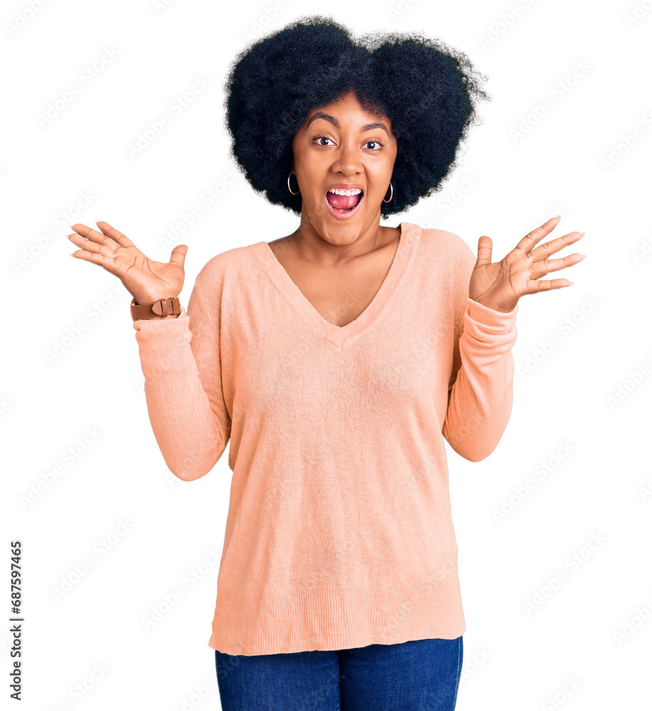 Young african american girl wearing casual clothes celebrating crazy and amazed for success with arms raised and open eyes screaming excited. winner concept Young african american girl wearing casual clothes celebrating crazy and amazed for success with arms raised and open eyes screaming excited. winner concept
