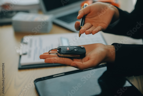 Salesman send key to customer after good deal agreement, successful car loan contract buying or selling new vehicle. © ARMMY PICCA