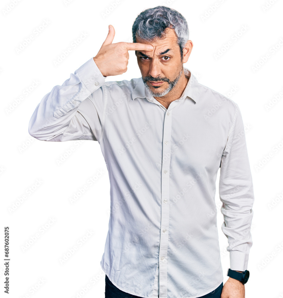 Middle age hispanic with grey hair wearing casual white shirt pointing unhappy to pimple on forehead, ugly infection of blackhead. acne and skin problem Middle age hispanic with grey hair wearing casual white shirt pointing unhappy to pimple on forehead, ugly infection of blackhead. acne and skin problem