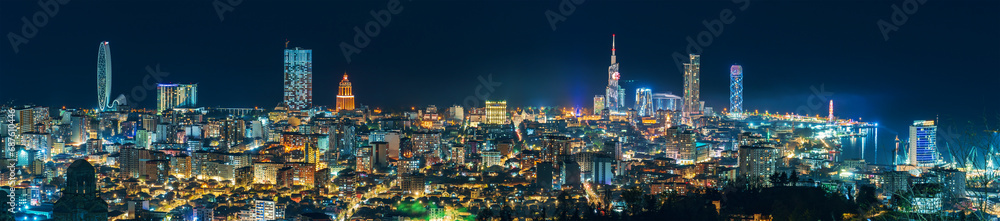 Batumi night cityscape wide panorama with modern hotels, tower buildings on Black Sea coast, Georgia. View from upper station of cable car located on mountain.