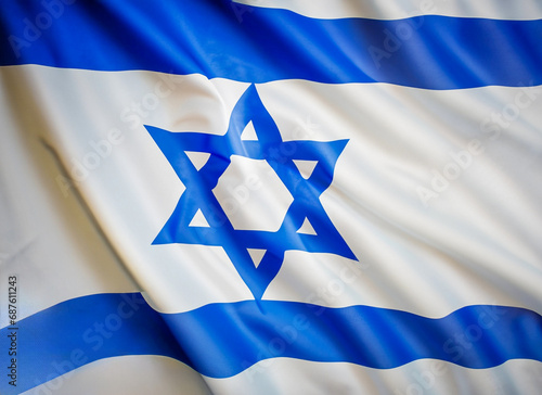 National flag of Israel fluttering in the wind. Israeli flag waving in the wind. Front closing view. White and blue flag with Star of David.