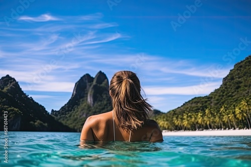 Young woman in bikini relaxing in an infinity pool on a tropical island, Young woman swimming in clear sea water in lagoon and looking at beautiful landscape. Travelling tour in Asia, AI Generated © Iftikhar alam