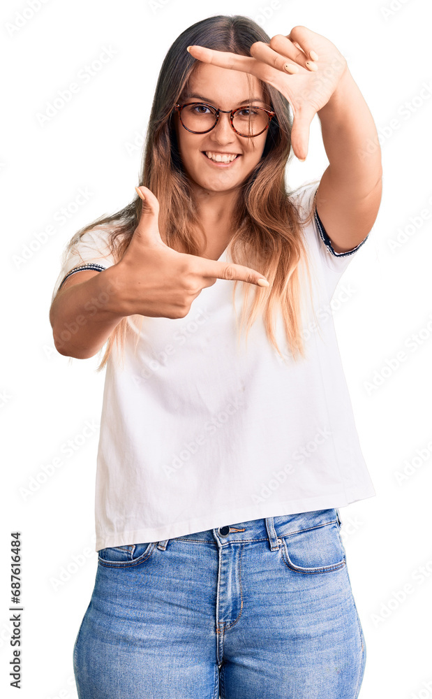 Fototapeta premium Beautiful caucasian woman wearing casual clothes and glasses celebrating achievement with happy smile and winner expression with raised hand