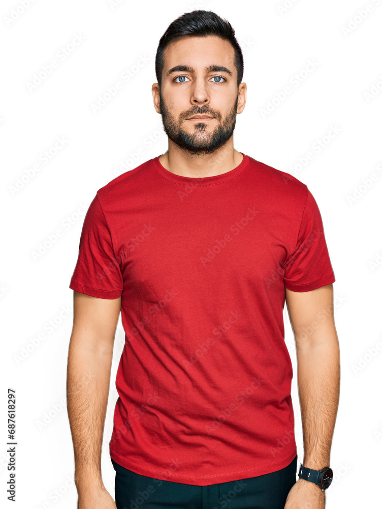 Young hispanic man wearing casual clothes with serious expression on face. simple and natural looking at the camera. Young hispanic man wearing casual clothes with serious expression on face. simple and natural looking at the camera.