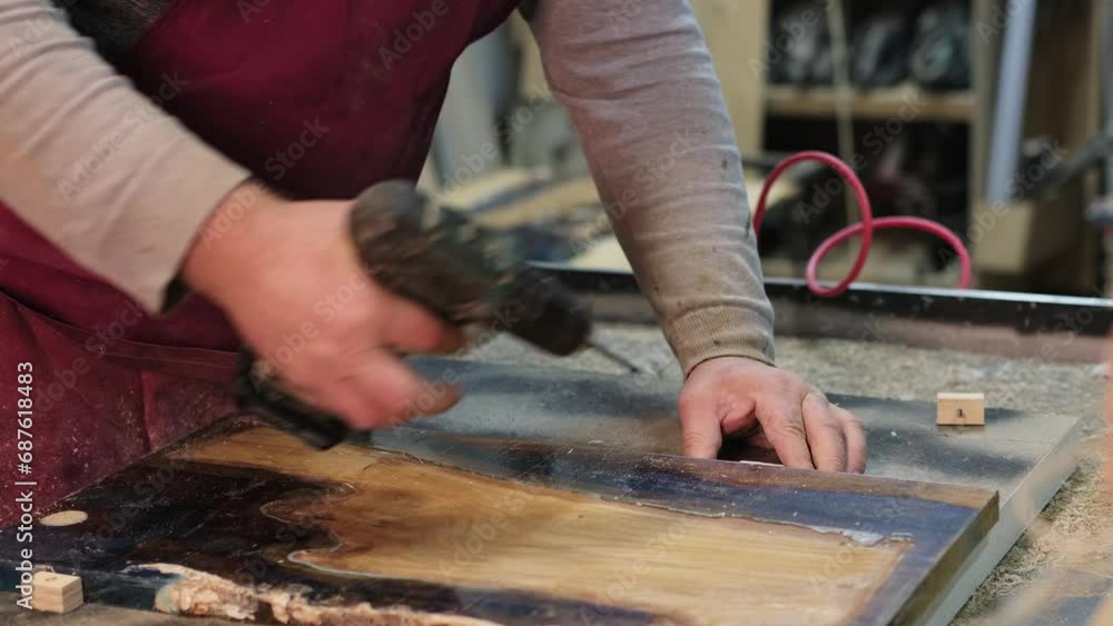 A focused craftsman drills into wood, hands steady and determined. Captures the dedication behind handmade furniture creation. A focused craftsman drills into wood, hands steady and determined. Captures the dedication behind handmade furniture creation.