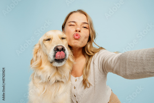 Close up young owner woman with her best friend retriever dog wear casual clothes do selfie shot pov mobile cell phone wink isolated on plain pastel light blue background. Take care about pet concept.