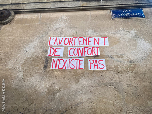 "comfort abortion does not exist" French protest poster stuck on a wall in Paris, France