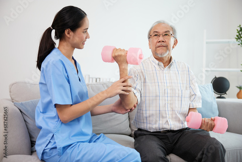 nurse or caregiver helping elderly patient to physiotherapist and exercise for rehabilitation at home