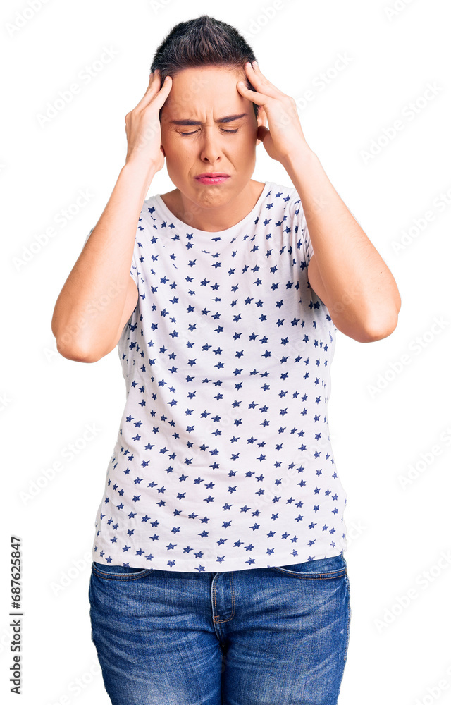 Young woman with short hair wearing casual clothes suffering from headache desperate and stressed because pain and migraine. hands on head. Young woman with short hair wearing casual clothes suffering from headache desperate and stressed because pain and migraine. hands on head.