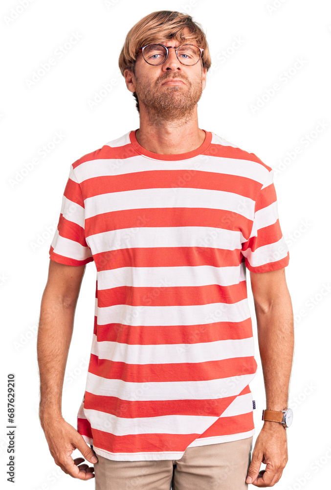Handsome caucasian man with beard wearing casual clothes and glasses relaxed with serious expression on face. simple and natural looking at the camera. Handsome caucasian man with beard wearing casual clothes and glasses relaxed with serious expression on face. simple and natural looking at the camera.